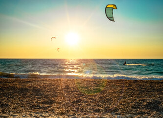 kitesurfers and sunset flare