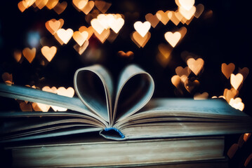 Paper book in the shape of a heart on the background of bokeh hearts. valentine's day concept.love...