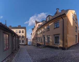 Old 1700s apartment houses with tin roofs and chimneys in the district Södermalm a winter day in Stockholm