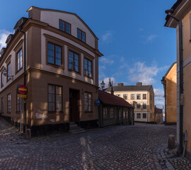 Old 1700s apartment houses with tin roofs and chimneys in the district Södermalm a winter day in Stockholm
