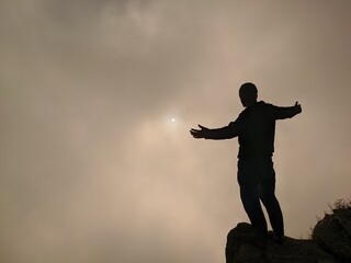 person on top of the clouds