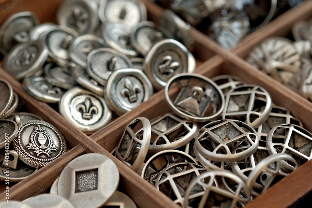 Wall mural metal sewing buttons in the assortment. tailoring.