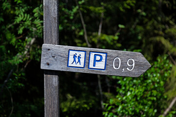 sign with icons for hiking and parking