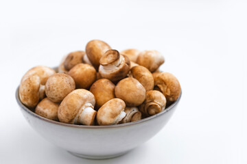 mushrooms champignon in  bowl on white background