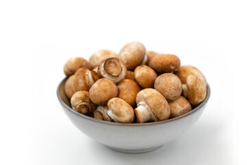 mushrooms champignon in  bowl on white background