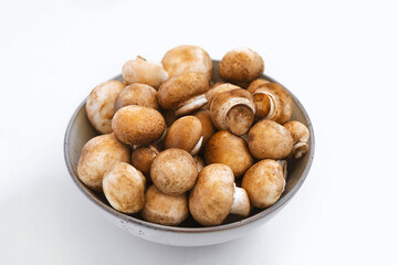 mushrooms champignon in  bowl on white background