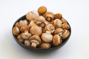 mushrooms champignon in  bowl on white background
