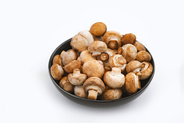 mushrooms champignon in  bowl on white background