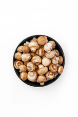 top view of fresh  mushrooms in bowl on white background