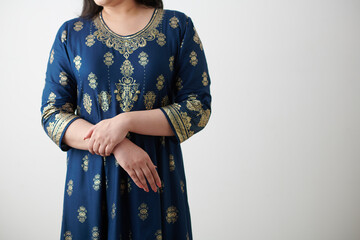 Croped image of woman in traditional Indian dress with golden embroidery looking away