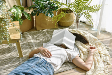 Woman chilling and sleeping in living room, Artificial plant, Indoor tropical natural houseplant for home interior and air purification. © ARTFULLY-79