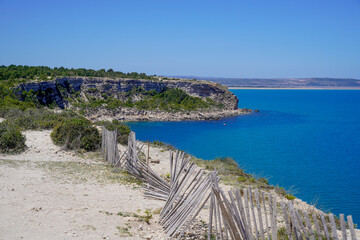 wooden fence coast protect fall coastal cliff in mediterranean in Occitanie southeast france - obrazy, fototapety, plakaty