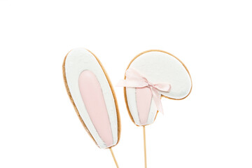 Sweet gingerbread cookies decorated with icing in the form of two Easter bunny ears. Easter concept 