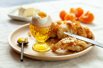 Breakfast with fresh pastries, fruits and egg on light table