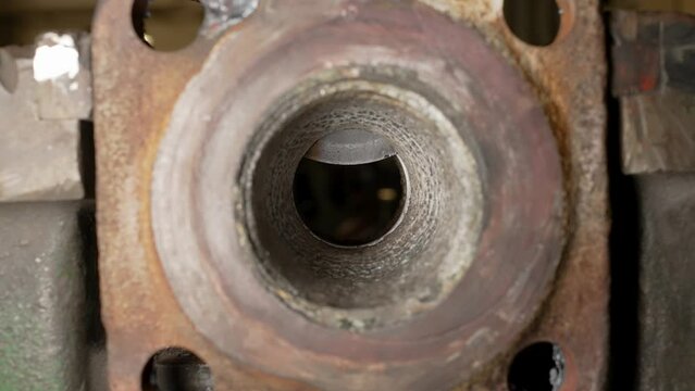 
closing a metal wedge valve through which the liquid must flow. inside view. medium close up