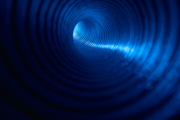 Neon swirl. Blur glow background. Futuristic radiance. Fluorescent tunnel. Defocused led blue color light ray in grooved bokeh rings texture pipe on dark black.