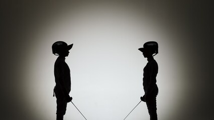 Black silhouettes of two female swordsmen fighting a duel. Athletes cross rapiers and deliver...