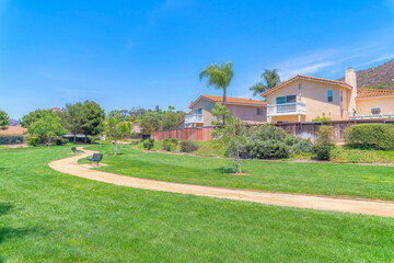 Park with green lawn and dirt trail in the middle at San Diego, California