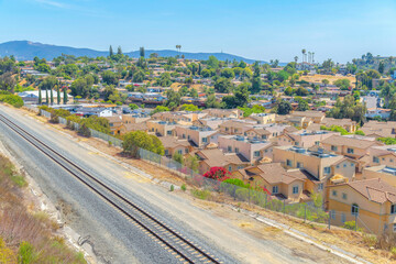 Railway tracks with mesh fence near the houses at San Marcos, San Diego, California