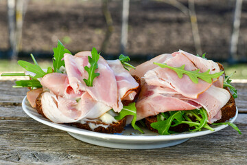 Home made healty Ketogenic diet sandwich fromWholegrain low carb bread, smoked bacon and arugula.