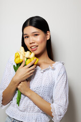 Portrait Asian beautiful young woman romance bouquet of flowers near the face isolated background unaltered