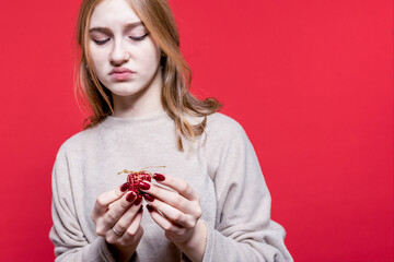 Disgusting gift. Exchange of gifts. Disappointment. Christmas. New year. Girl frustrated holding a small gift box in her hands. Birthday