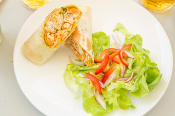 salad with chicken and vegetables wrap.