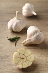 Bulbs of garlic on wooden background, close up