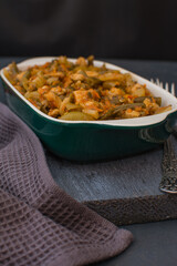 Vegetable stew with green beans and cauliflower in a green ceramic bowl.