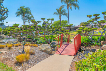 Small arched red bridge in a park at San Marcos, San Diego, California