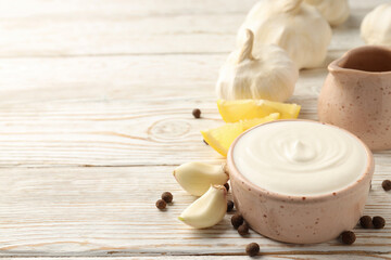 Concept of cooking garlic sauce on wooden background