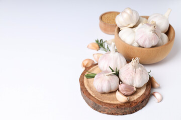 Garlic and mustard seeds on white background