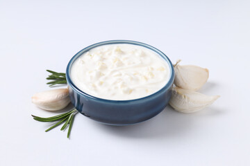Garlic sauce and ingredients on white background