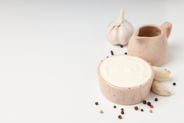 Garlic sauce and ingredients on white background