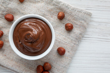 Homemade Chocolate Hazelnut Spread in a Bowl, top view. From above, overhead, flat lay. Copy space.