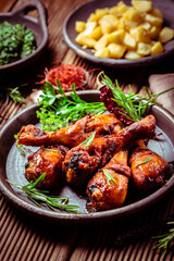 Marinated chicken drumsticks with baked potatoes and spinach