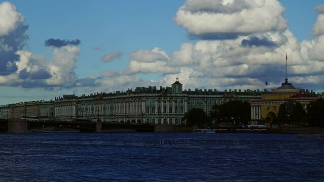 Dramatic cloudy sky over the Neva river in Saint Petersburg, Russia, with the Palace Bridge and Winter Palace - Hermitage Museum, timelapse 4k