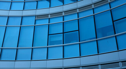 business building in city with mirror windows with reflections of blue sky.