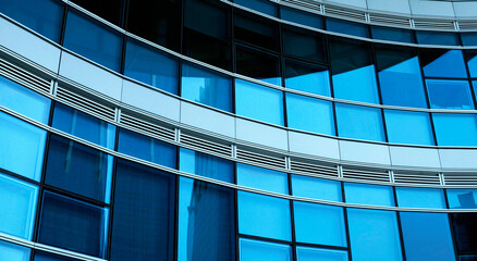 business building in city with mirror windows with reflections of blue sky.