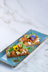 Two guacamole and salmon toasts