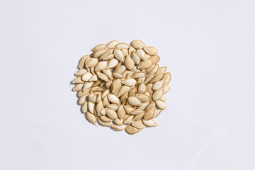 Heap of pumpkin seeds isolated on white background