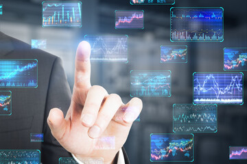 Close up of businessman finger pointing at various forex screens on blurry background. Cryptocurrency, bticoin trading and finance concept. Double exposure.