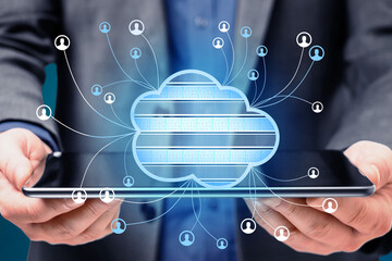 Close up of businessman hands holding tablet with abstract cloud computing hologram on blurry blue background. Technology, database, communication and connection concept. Double exposure.