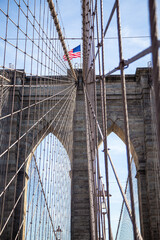 Fototapeta na wymiar Abstract view of the American Flag and the Brooklyn bridge in the USA