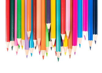 Wooden colored pencils isolated on a white background. A line of multicolored pencils in a large plan