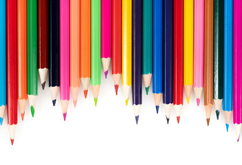 Wooden colored pencils isolated on a white background. A line of multicolored pencils in a large...