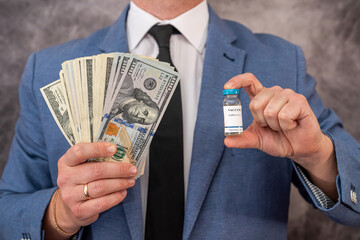 handsome handsome man in a chic suit from a cool brand holds a vaccine and dollars.