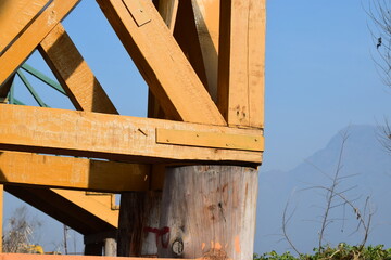 Closeup of Yellow wooden support under a bridge in winter dal lake