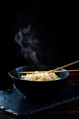 steamed egg noodles on a black background