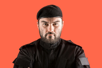 Law enforcement officer with a stern look. A male security guard in a black uniform and a cap with...